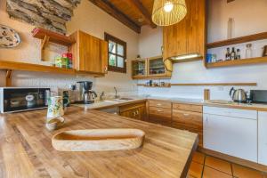 a kitchen with wooden cabinets and a wooden counter top at Chalet La Darse Nature et Sérénité in Villard-Reculas +28 photos