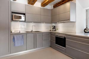 a kitchen with stainless steel cabinets and a microwave at Villa Arena in Geisingen