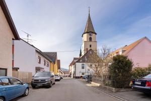 a small street with a church with a clock tower at Villa Arena in Geisingen