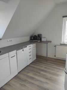 a kitchen with white cabinets and a counter top at Sachsen Rosie in Hartmannsdorf
