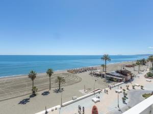 a view of a beach with palm trees and the ocean at Hanami Avenida de España Oceanfront in Estepona