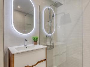 a white bathroom with a sink and a shower at Hanami Avenida de España Oceanfront in Estepona +15 photos