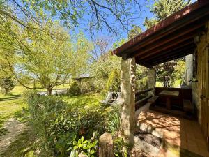 a porch of a house in a garden at Gufo in Pitigliano