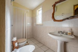 a bathroom with a toilet and a sink at Gufo in Pitigliano +25 photos