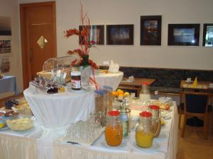 a table with food and drinks on it at Hotel Götz in Groß Kreutz
