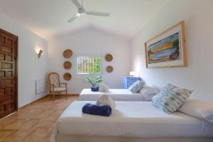 a living room with two beds and a couch at Almijan Alegria in Estepona +32 photos