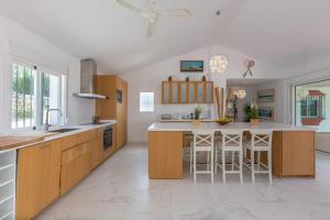 a kitchen with wooden cabinets and a large island at Almijan Alegria in Estepona
