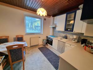 a kitchen with white cabinets and a table and a window at Apartment Gina in Stall