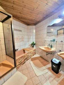 a bathroom with a tub and a sink at Apartment Gina in Stall +26 photos