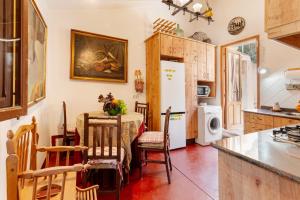 a kitchen with a table and a white refrigerator at Casica de Perintín in Ojós +26 photos