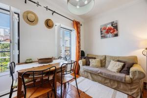 a living room with a couch and a table at Burgau - A Casa dos Avós in Burgau +22 photos