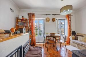 a kitchen and living room with a table and chairs at Burgau - A Casa dos Avós in Burgau