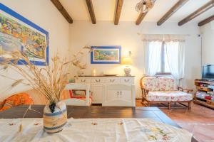 a living room with a vase on a table at La Casa del Vento Plemmirio in Plemmirio +37 photos