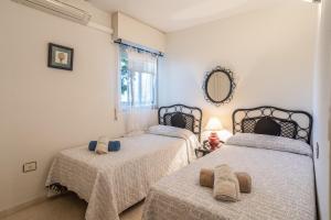 a bedroom with two beds and a mirror at Apartment with Swimming-pool in Marbella +21 photos