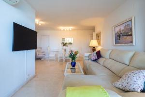 a living room with a couch and a tv at Apartment with Swimming-pool in Marbella