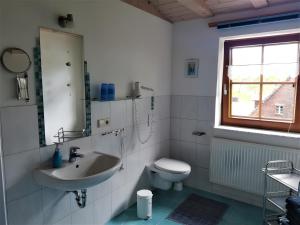 a white bathroom with a sink and a toilet at Sigmundenhof Schonach in Ölberg +67 photos