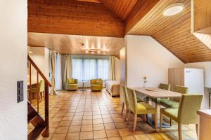a living room with a dining room table and chairs at Haus Azalea in Olsberg
