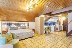 a large bedroom with a bed and a kitchen at Haus Azalea in Olsberg