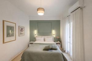 a bedroom with a bed and a large window at Wake in the Lake III in Agios Nikolaos