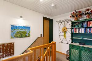a staircase in a home with a green book shelf at Haus Sielblick in Wangerland
