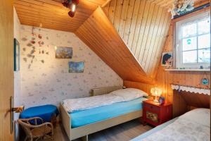 a bedroom with two beds in a attic at Haus Sielblick in Wangerland