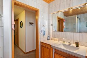 a bathroom with a sink and a mirror at Haus Sielblick in Wangerland +69 photos