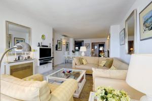 a living room with two couches and a tv at Apartment - Car included in Estepona