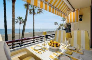 a dining room with a table with a view of the beach at Apartment - Car included in Estepona