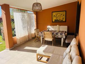 a living room with a table and a couch at 20 steps from the beach VILLINO STECU in Costa Rei