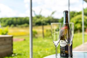 a bottle of champagne sitting next to a wine glass at Kleine Auszeit in Thalheim