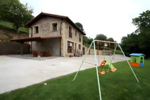a yard with a playground in front of a house at Los Cerezos in Rada