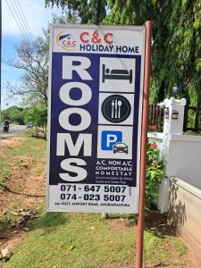 a sign for a holiday home on the side of a road at C&C Holiday Home in Nikawatawana