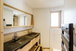 a bathroom with a sink and a mirror at Meribel le chalet d'eugénie in Les Allues
