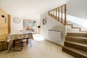 a kitchen and dining room with a table and stairs at Meribel le chalet d'eugénie in Les Allues