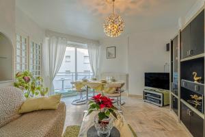 a living room with a couch and a table at Appartement Le Rial - Erquy in Erquy