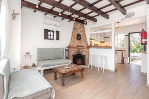 a living room with a couch and a fireplace at Villa Kassiopea in Cala Blanca