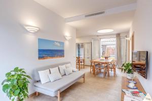 a living room with a couch and a table at Es Pop Nou in Sa Ràpita