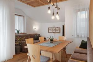 a dining room with a table and a couch at Prielerhof in San Lorenzo di Sebato