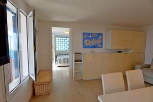 a kitchen and living room with a table and chairs at La Perla del Golfo in Capoliveri
