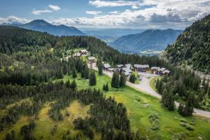 an aerial view of a village in the mountains at Fleury in Mieussy