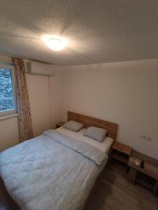 a bedroom with a bed with two pillows on it at Guesthouse Flaghome in Mostar