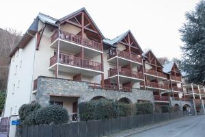 a building with balconies on the side of a street at T2 avec piscine couverte et parking in Saint-Lary-Soulan