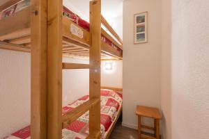 a bunk bed in a small room with a bunk bed in a bedroom at T2 avec piscine couverte et parking in Saint-Lary-Soulan +16 photos