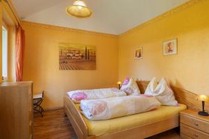 a bedroom with a bed with pillows on it at Ferienhaus Gerster in Mitten