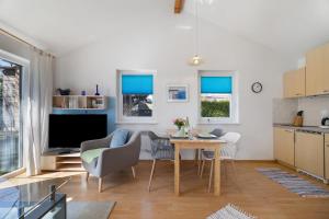 a kitchen and living room with a table and chairs at Ferienhaus Gerster in Mitten +20 photos