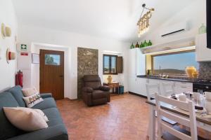 a living room with a couch and a table and a kitchen at Casas do Monte I in Giões