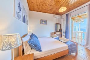 a bedroom with a bed with a view of the ocean at Dolphin villa 2 in Gaios