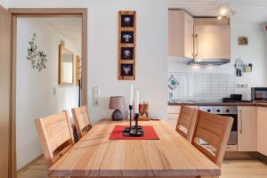 a dining room table with a candle on top of it at Ferienwohnung am Schwellenweiher in Feldberg +23 photos