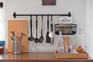 a group of kitchen utensils hanging on a wall at Ferienwohnung am Schwellenweiher in Feldberg
