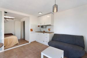 a living room with a couch and a kitchen at Apartamento El Moral in Frontera +14 photos